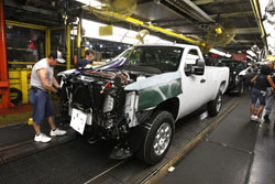 A assembly-line worker works on a 2011 GMC Sierra at the Flint Assembly in Flint, Mich. General Motors said Wednesday its August sales dropped 7 percent compared with July.