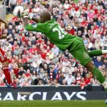 Liverpool's Luis Suarez, left, has his shot saved by Wigan Athletic goalkeeper Ali al Habsi during an English Premier League soccer match