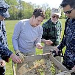 United States Naval Academy adjunct assistant professor Mechelle Kerns Galway, center left, shows volunteers how to comb through the dirt and keep an eye out for potential artifacts in Annapolis.