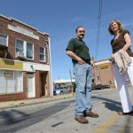 Rich Marsiglia (left) and Regina Lansinger, leaders of Hamilton-Lauraville Main Street, stand outside of the original Hamilton firehouse that the group bought this month for $64,900.