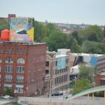 A sign denoting the Station North Arts and Entertainment District sits atop the Copycat Building, a former industrial warehouse turned artist housing project. (Josh Cooper/The Daily Record)
