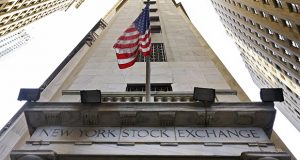 FILE - In this Friday, Nov. 13, 2015, file photo, the American flag flies above the Wall Street entrance to the New York Stock Exchange. Stocks are opening higher on Wall Street, Tuesday, Aug. 22, 2017, and some of the biggest gains went to retailers and technology companies. (AP Photo/Richard Drew, File)