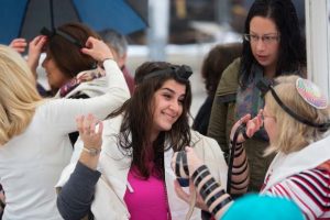 In this Feb. 7, 2016, file photo, Israeli women wear Tefillin, also known as Phylacteries - small leather boxes containing religious texts usually worn by Jewish men, at the Western Wall, the holiest site where Jews can pray in Jerusalem's Old City. (AP Photo/Sebastian Scheiner, File)