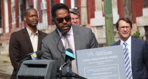 Dean S. Harrison, principal of Upton Renaissance LLC, holds a certificate from the city showing the firm was selected to build 38 homes as part of revitalization efforts in west Baltimore's Upton neighborhood. (Adam Bednar)