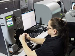 An operator uses The Crowley Co.'s Mekel Technology Mach10 microfilm scanner in this undated photo. At right is a MACH7 microfiche scanner. (The Crowley Co. photo)