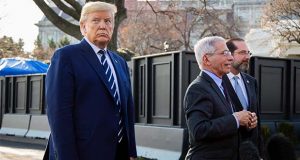 President Donald Trump with Director of the National Institute of Allergy and Infectious Diseases at the National Institutes of Health Anthony Fauci, center, and Department of Health and Human Services Secretary Alex Azar, speaks to reporters on the South Lawn, Tuesday, March 3, 2020, in Washington, as they arrive at the White House from a visit to the National Institutes of Health's Vaccine Research Center in Bethesda, Md. (AP Photo/Manuel Balce Ceneta)