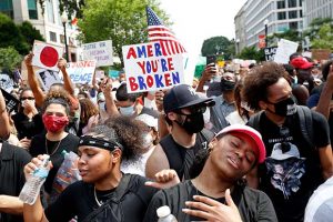 TiMia White of Washington, right, dances as she protests Saturday, June 6, 2020, near the White House in Washington, over the death of George Floyd, a black man who was in police custody in Minneapolis. Floyd died after being restrained by Minneapolis police officers. (AP Photo/Jacquelyn Martin)
