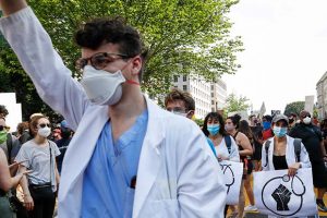 Doctors protest Saturday, June 6, 2020, near the White House in Washington, over the death of George Floyd, a black man who was in police custody in Minneapolis. Floyd died after being restrained by Minneapolis police officers. (AP Photo/Jacquelyn Martin)