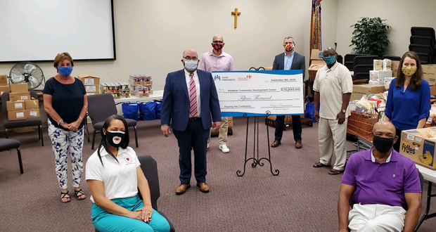 Officials with area nonprofit groups and Kaiser Permanente practice social distancing during a $15,000 donation presentation from Kaiser Permanente to the Rainbow Community Development Center. From left and front to back are the Rev. Patricia Drumming, executive director of the Rainbow Community Development Center; Pastor Horace Drumming, Rainbow Community Development Center; Marla Caplon, director of student wellness initiatives with Montgomery County Public Schools; George L. Leventhal, Ph.D., director of community health with Kaiser Permanente; Jewru Bandeh, regional director for Montgomery County with the East County Regional Services Office; Michelle Caruso, program manager with Alliance for a Healthier Generation; Montgomery County Councilmember Tom Hucker; Council Vice President Patrick M. Campbell, senior planning manager in the Office of Emergency Management and Mass Care Operations with Montgomery County Department of Health and Human Services. (Courtesy of Rainbow Community Development Center).