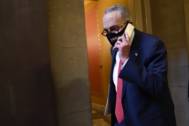 Senate Minority Leader Sen. Chuck Schumer of N.Y., walks on Capitol Hill in Washington, Tuesday, Dec. 15, 2020. (AP Photo/Susan Walsh)