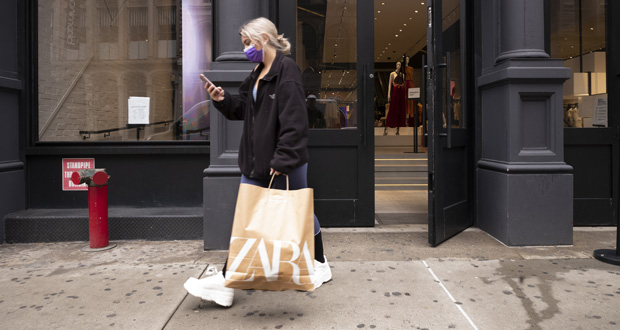 A customer walks out of a Zara store, Thursday, March 25, 2021, in New York. U.S. consumer confidence rose sharply for a second straight month in April, hitting the highest level in more than a year as consumer sentiment was boosted by a more rapid rollout of the vaccines and another round of support payments. (AP Photo/Mark Lennihan)
