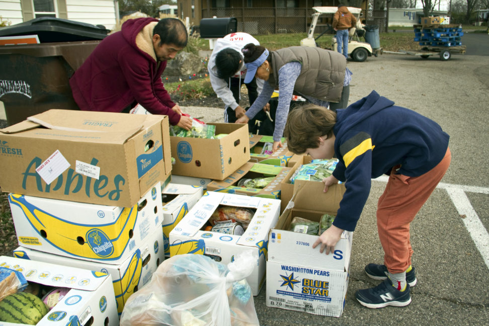 In this image provided by Last Mile Food Rescue, food is distributed at a Last Mile Food Rescue pop-up food pantry in a Cincinnati parking lot in November 2021. Nonprofits of all kinds are getting hit hard by inflation, experts say. (Denise Johnson/Last Mile Food Rescue via AP)