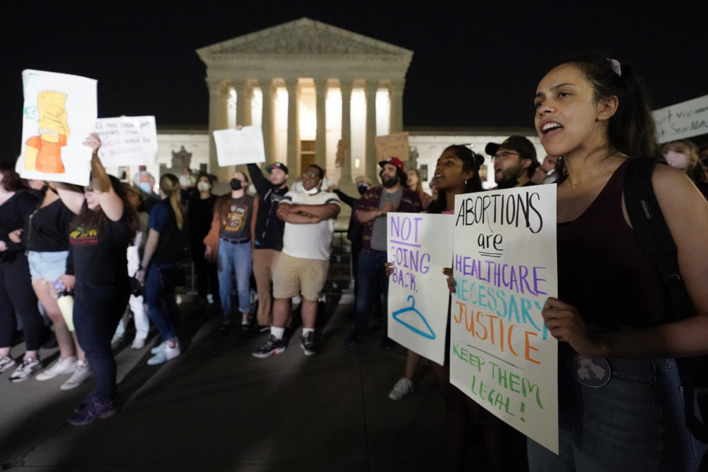 A crowd of people gather outside the Supreme Court early Tuesday, May 3, 2022, in Washington. A draft opinion circulated among Supreme Court justices suggests that earlier this year a majority of them had thrown support behind overturning the 1973 case Roe v. Wade that legalized abortion nationwide, according to a report published Monday night in Politico. (AP Photo/Alex Brandon)