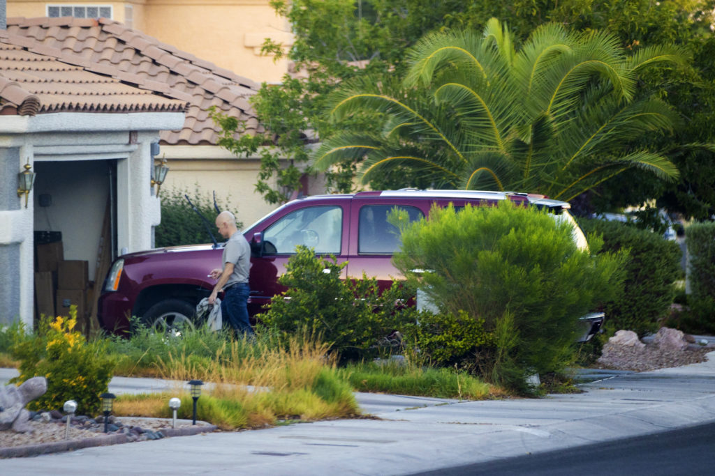 Outgoing Clark County Public Administrator Robert Telles washes his car outside his home on Sept. 6, 2022, in Las Vegas. Authorities served search warrants at Telles' home on Sept. 7, 2022, in connection with the fatal stabbing of Las Vegas Review-Journal investigative reporter Jeff German. (Benjamin Hager/Las Vegas Review-Journal via AP)