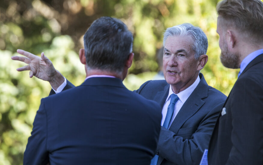 Federal Reserve Chair Jerome Powell, center, talks with attendees of the central bank's annual symposium at Jackson Lake Lodge in Grand Teton National Park in Moran, Wyoming, on Aug. 26, 2022. (AP Photo/Amber Baesler, File)