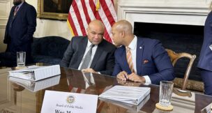 State Treasurer Dereck Davis (left) and Gov. Wes Moore (right) convene after a meeting of the Board of Public Works on Jan. 31, 2024, where each addressed news reports about a sale of the Baltimore Orioles. (Sapna Bansil/Capital News Service)