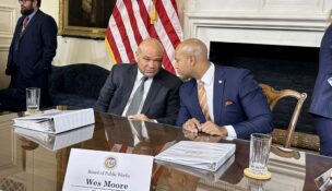 State Treasurer Dereck Davis (left) and Gov. Wes Moore (right) convene after a meeting of the Board of Public Works on Jan. 31, 2024, where each addressed news reports about a sale of the Baltimore Orioles. (Sapna Bansil/Capital News Service)