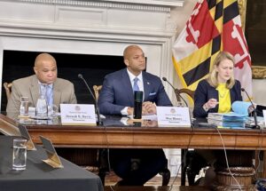 From left, State Treasurer Dereck Davis, Gov. Wes Moore and Comptroller Brooke Lierman listen to a speaker at a meeting of the Board of Public Works on March 13, 2024. (Sapna Bansil/Capital News Service)