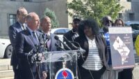 Brian Schwalb, attorney general for the District of Columbia, second from left, and Maryland Attorney General Anthony Brown, third from left, speak outside the federal courthouse in Washington on Sept. 3, 2024. Three gun shops that sold dozens of firearms to a man who trafficked the weapons in and around Washington, D.C., are facing a new lawsuit filed jointly Tuesday by attorneys general for Maryland and the nation’s capital. (AP Photo/Lindsay Whitehurst)