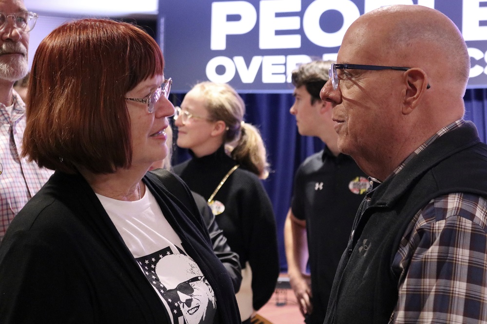 Republican former Gov. Larry Hogan talks to a supporter