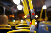 Interior of a bus with stop button (Depositphotos)
