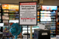 A sign in a Kwik Trip store shows the store will no longer be using pennies to give change, on Oct. 23, 2025, in Yorkville, Wisconsin. (AP Photo/Morry Gash)