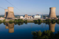 At Constellation's nuclear power plant on Three Mile Island, called the Crane Clean Energy Center, near Middletown, Pennsylvania, the cooling towers are reflected in the Susquehanna River at sunrise on June 25, 2025. (AP Photo/Ted Shaffrey, File)