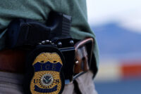 The badge of a U.S. Immigration and Customs Enforcement (ICE) agent is seen at the airport in El Paso, Texas, on May 10, 2023. (USA TODAY Network)