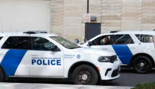 Two Department of Homeland Security vehicles outside of Hyattsville Immigration Court.(Sam Gauntt/Capital News Service)