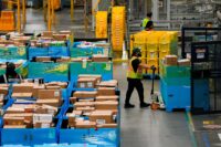 Workers move products during Cyber Monday at Amazon's fulfilment center in Robbinsville, New Jersey, on Dec. 1, 2025. (REUTERS/Eduardo Munoz)