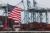 A U.S. flag flutters in front of shipping containers at the Port of Long Beach in Long Beach, California, July 11, 2025. (REUTERS/Daniel Cole)