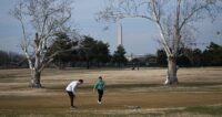 Jack Faraone barely misses a putt as Cameron Levine reacts while they play golf in January at East Potomac Golf Links in Washington, D.C. (Matt McClain/The Washington Post)