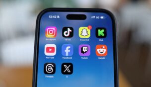 Instagram, TikTok, Snapchat, Kick, YouTube, Facebook, Twitch, Reddit, Threads and X applications are displayed on a mobile phone in this picture illustration taken on Dec. 9, 2025. (REUTERS/Hollie Adams/Illustration//File Photo)