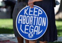 A person holds a placard during a 'Walk-Out for Women' rally in Los Angeles on June 24, 2024, on the second anniversary of the U.S. Supreme Court overturning Roe v. Wade. (REUTERS/Mike Blake)