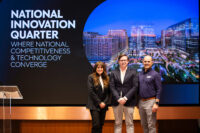 From left: Tracy Sayegh Gabriel, president and CEO of the National Landing BID; Evan Regan-Levine, chief strategy officer at JBG Smith; and Michael Hauser, managing partner SAIC, gather at the Feb. 11, 2026, launch of National IQ at the National Landing Experience Center. (Conner McLaren for National IQ)