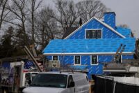 A construction worker stands on top of a residential housing project in Garden City, New York, on March 13, 2026. (REUTERS/Shannon Stapleton)