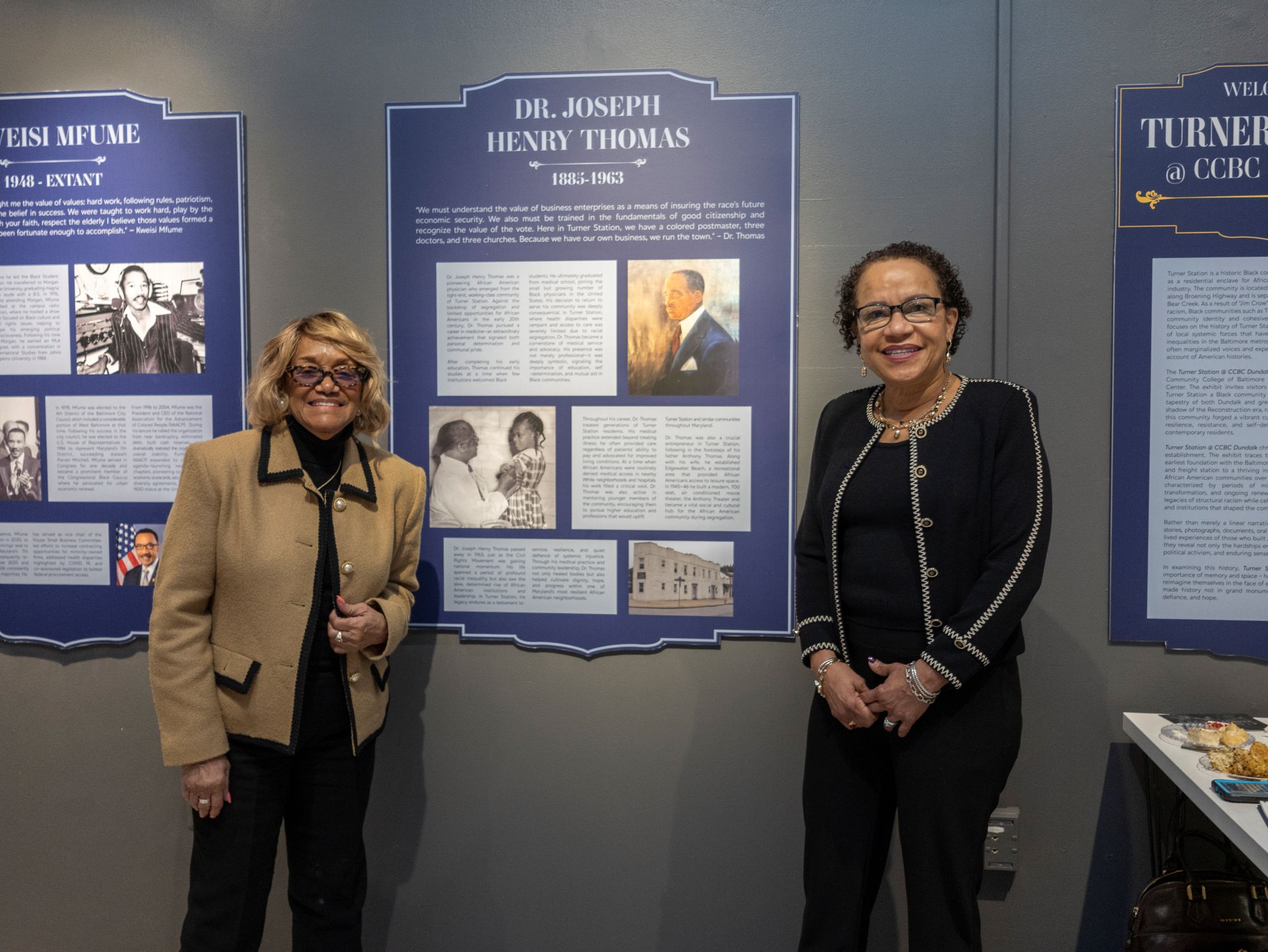 The exhibit honors former residents of Turner Station, including Dr. Joseph Henry Thomas, a prominent community physician and entrepreneur. Two of his descendants, Stephanie Covington (left) and Laura Brooks, gather by his plaque. (Eye See You Photography LLC/Zeinab Shafiee/Samantha Trionfo)