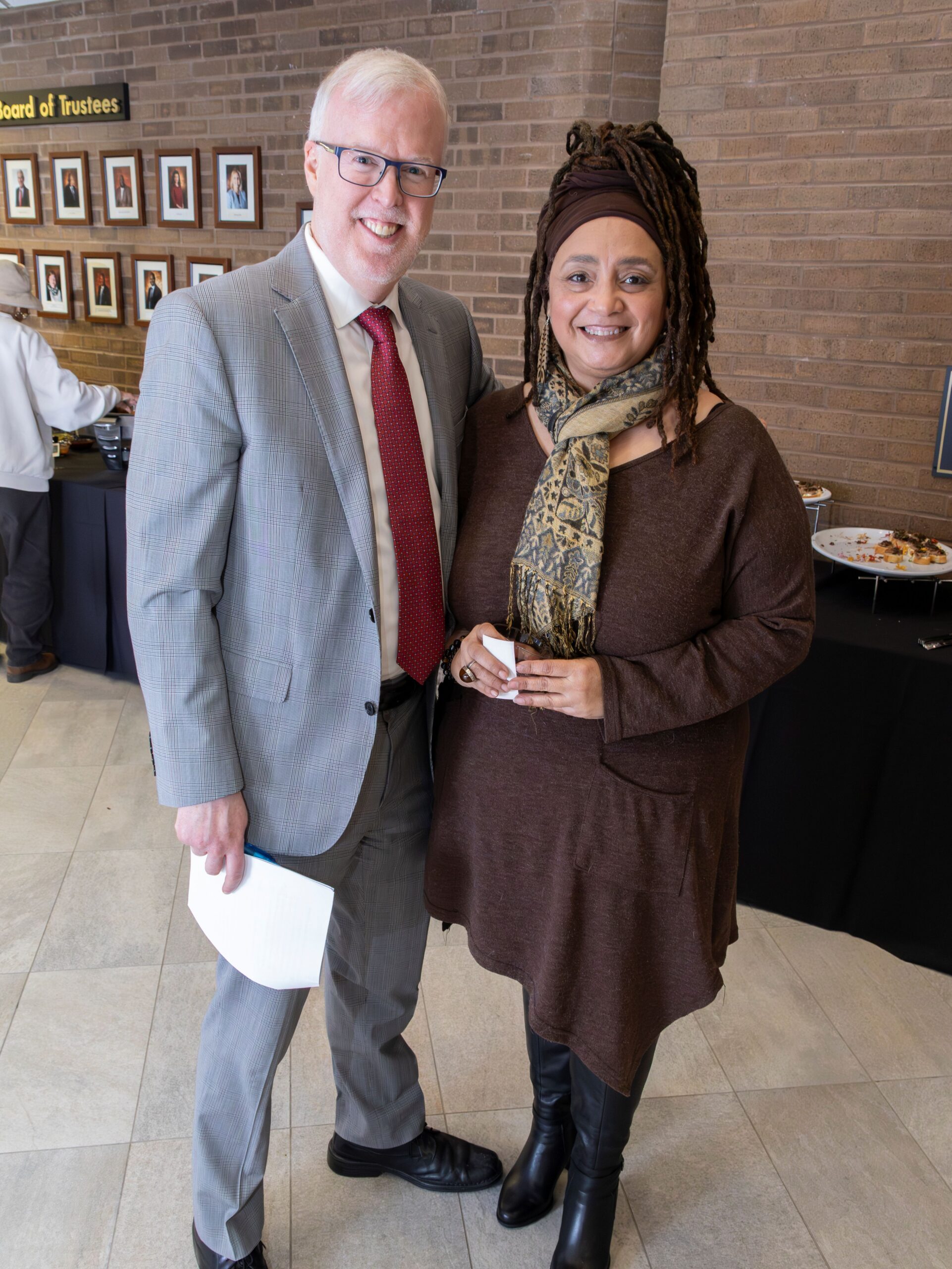 CCBC School of Arts and Communication Dean R. Michael Walsh, left, congratulated historian Michelle Wright, right, CCBC assistant professor of history and Africana studies, who curated the exhibit. (Eye See You Photography LLC/Zeinab Shafiee/Samantha Trionfo)