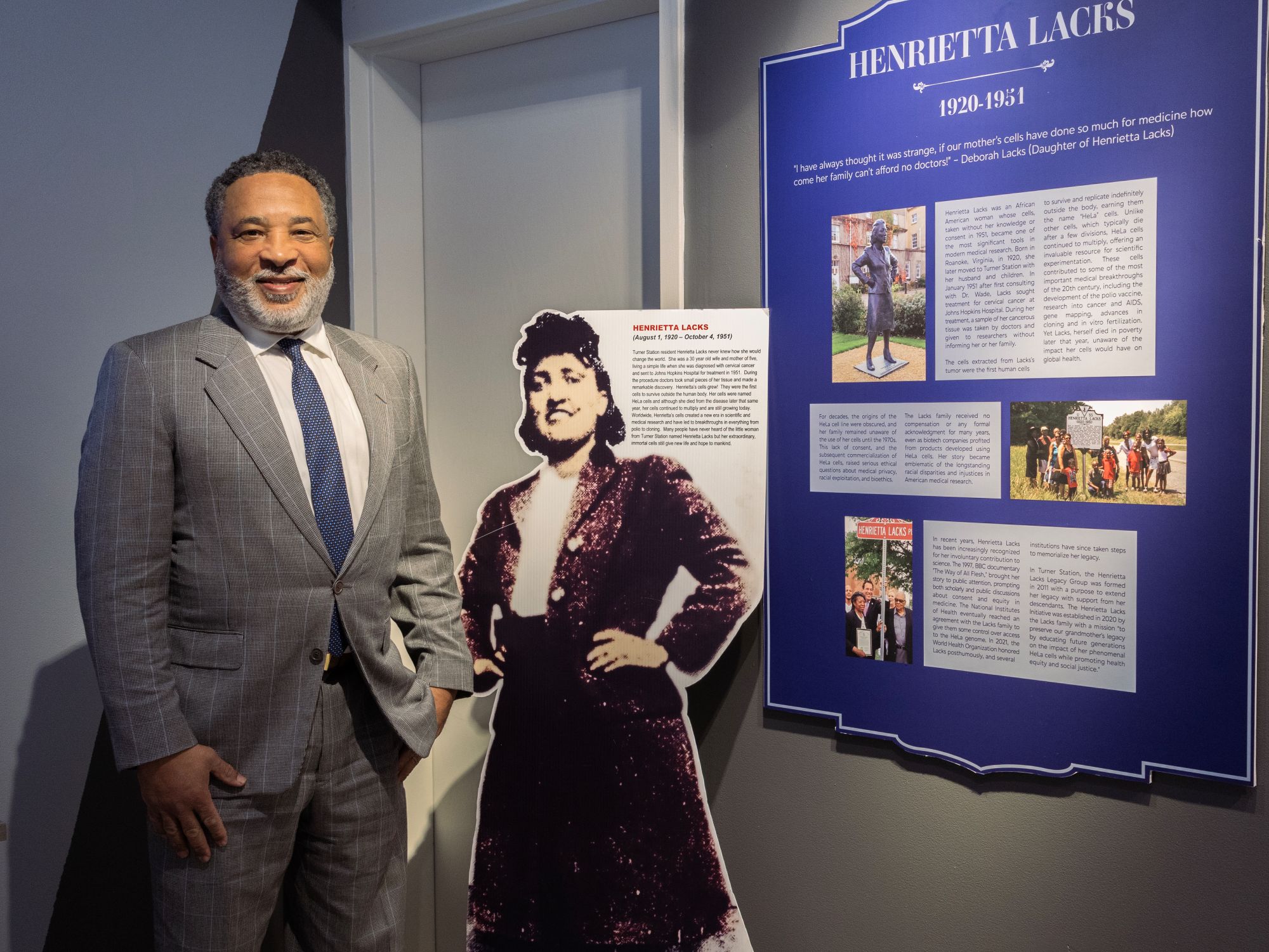 Alfred Lacks-Carter Jr., grandson of Henrietta Lacks, smiles as he visits with the plaque and large cut-out photograph celebrating his grandmother. (Eye See You Photography LLC/Zeinab Shafiee/Samantha Trionfo)