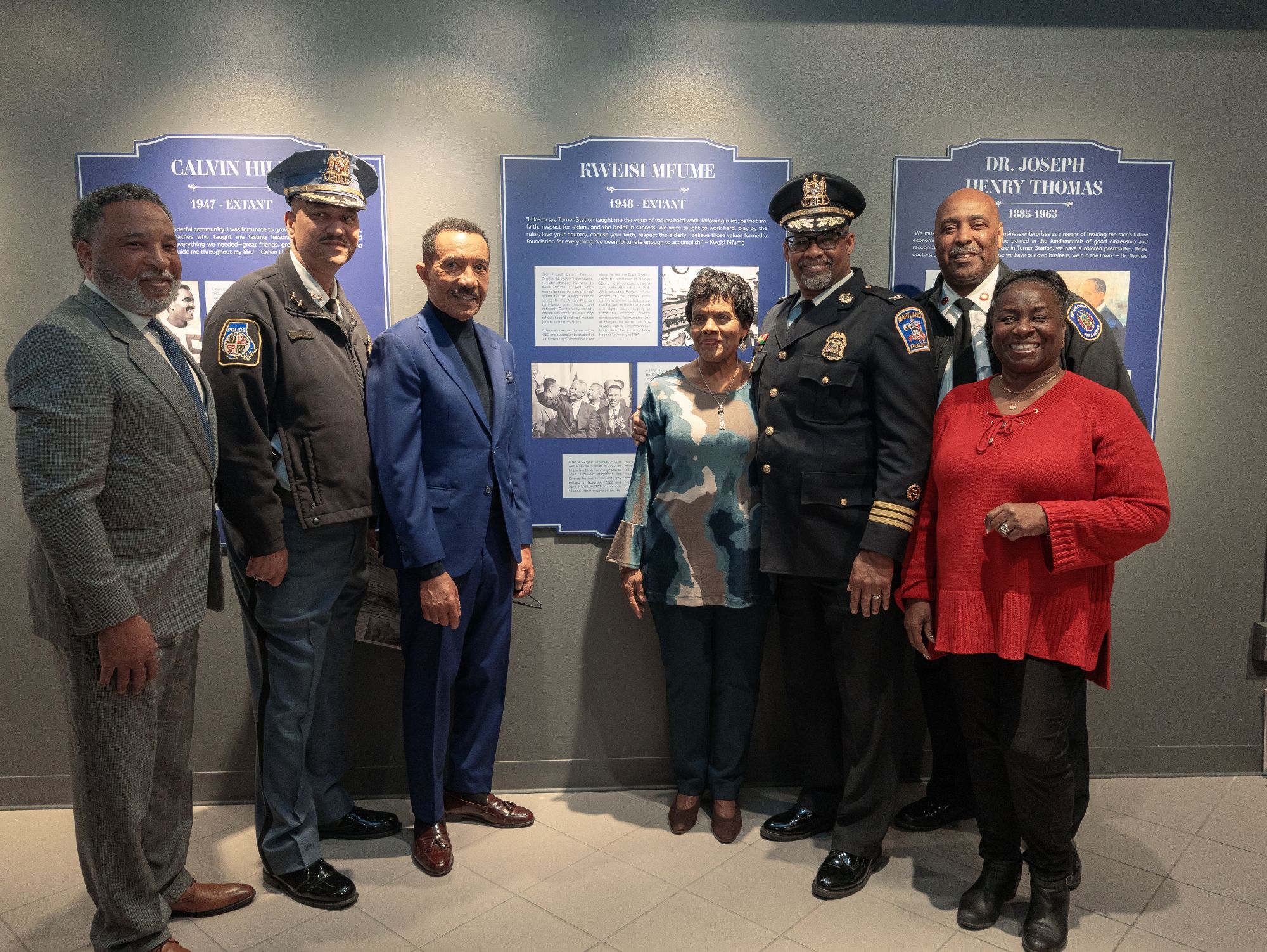Residents and former residents of Turner Station gather around the plaque honoring U.S. Rep. Kweisi Mfume. From left to right, Alfred Lacks-Carter Jr., grandson of Henrietta Lacks; Robert McCullough, Baltimore County Police Chief; U.S. Rep. Kwesi Mfume; Edythe Brooks, Co-Chair, Turner Station History Center; Glend McGuire, Acting Chief, Maryland Capital Police; Louis Winston, Howard County Fire Chief; Mandy Breedlove, Co-Chair, Turner Station History Center. (Eye See You Photography LLC/Zeinab Shafiee/Samantha Trionfo)