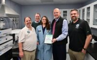 Environmental chemist Leah Griffin (center), who leads the team at the county’s PFAS lab, is joined by (from left) William Smith Jr., Superintendent of Laboratories for the Harford County DPW Division of Water and Sewer; Lawrence Slattery, Chief of Operations for the division; County Executive Bob Cassilly; and Auther Hannon III, senior computer engineer for the division. (Harford County)