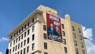 An 'Injured, hon?' ad for WGK Personal Injury Lawyers on the Old Town National Bank building at Fallsway and North Gay Street in downtown Baltimore.