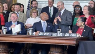 Senate President Bill Ferguson, Gov. Wes Moore and House Speaker Joseline Peña-Melnyk sign the fiscal year 2027 budget on April 8, 2026. (Hannah Gaskill/The Daily Record)