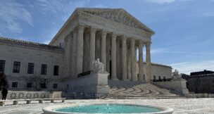 A person stands near the U.S. Supreme Court building in Washington on March 14, 2026. (REUTERS/Will Dunham/File Photo)