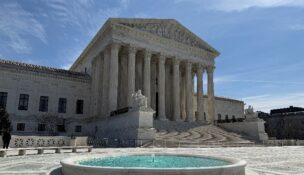 A person stands near the U.S. Supreme Court building in Washington on March 14, 2026. (REUTERS/Will Dunham/File Photo)