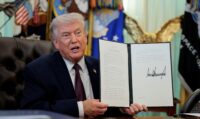 President Donald Trump speaks as he shows a signed executive order on mail ballots, in the Oval Office of the White House in Washington on March 31, 2026. (REUTERS/Evan Vucci)