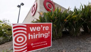 A sign posted outside a Target store states the company is hiring in Encinitas, California, on March 30, 2026. (REUTERS/Mike Blake)