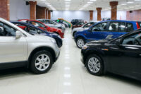 New fuel efficient SUVs on a car dealers lot for sale by Depositphotos