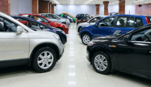New fuel efficient SUVs on a car dealers lot for sale by Depositphotos