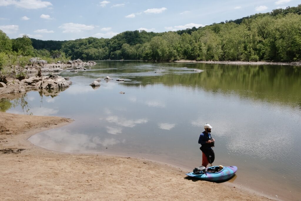 Eli Geisenberger puts his kayak in the Potomac River by Fletcher's Path and Old Angler's Inn on April 27. (Jordan Tovin/For The Washington Post)